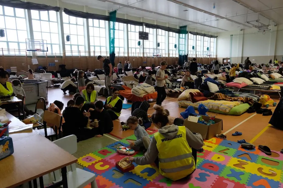 On March 9, 2022 in Medyka, southeast Poland, children play in the corner of a school gymnasium set up to host refugee families fleeing the war in Ukraine. 