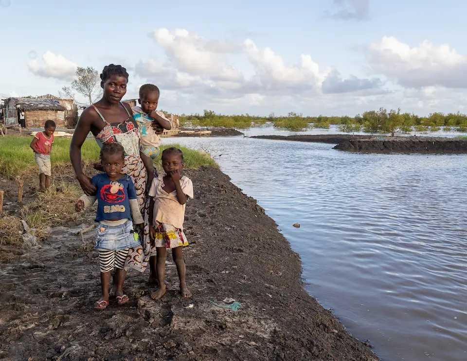 A mother a three children stand in flood waters in Mozambique.