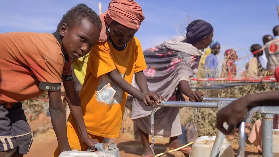 Children collect water at a UNICEF-supported access point in Tawila, North Darfur, Sudan.