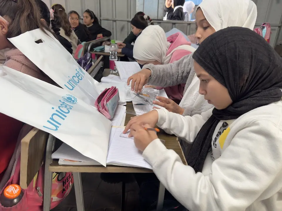 Children in Deir El Balah, Gaza Strip, use School-in-a-Box supplies from UNICEF inside a temporary classroom..