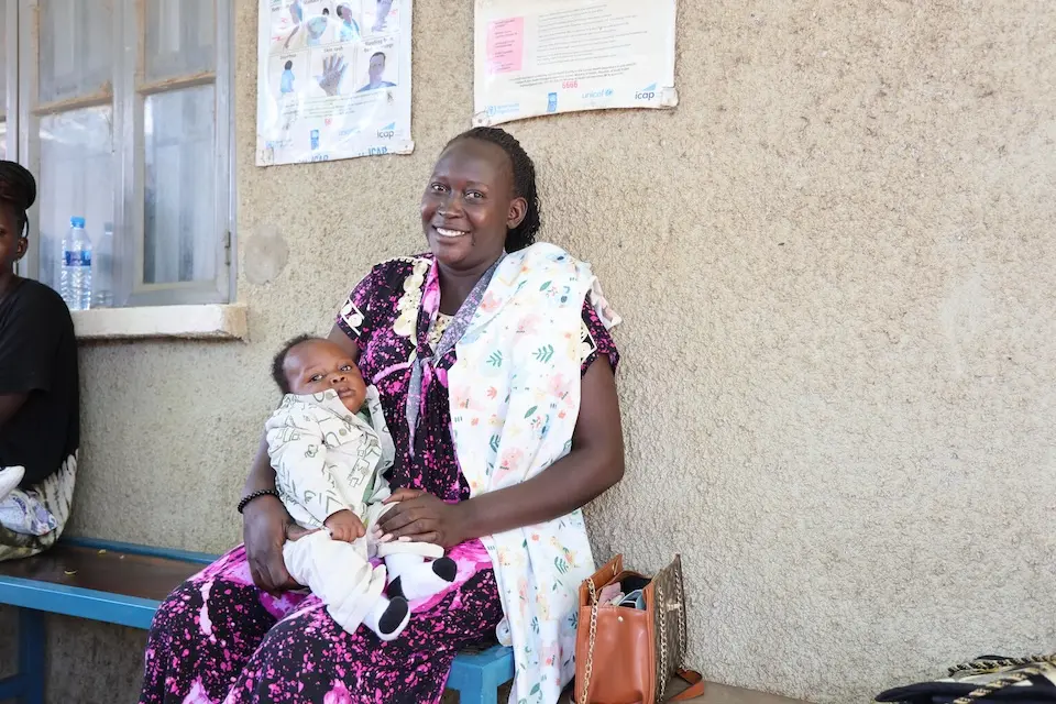 A mother holds her baby boy as they wait for vaccination at UNICEF-supported Munuki Primary Health Care Center in Juba, South Sudan. 