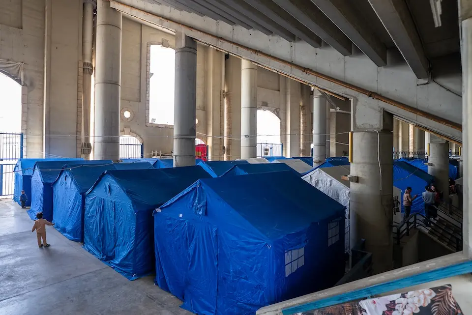 At the Sports City complex in Beirut on March 18, 2026, tents are set up to house families fleeing bombardment.