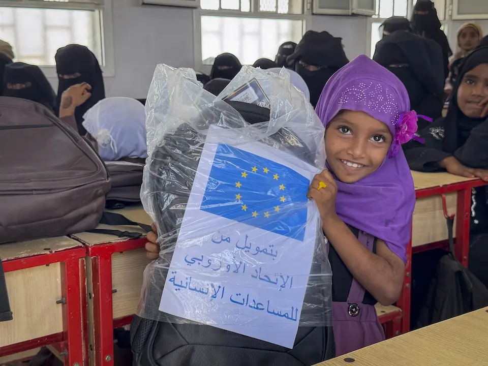 A 6-year-old student receives a school bag with learning materials in Hudaydah, Yemen. from UNICEF.