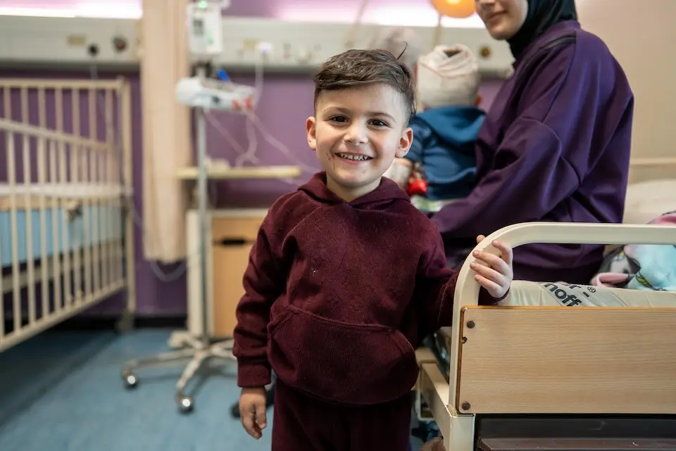 On April 9, 2026 in Beirut, a 3-year-old holds onto the hospital bed where his 10-month-old brother is being treated for injuries sustained during an Israeli air strike. 