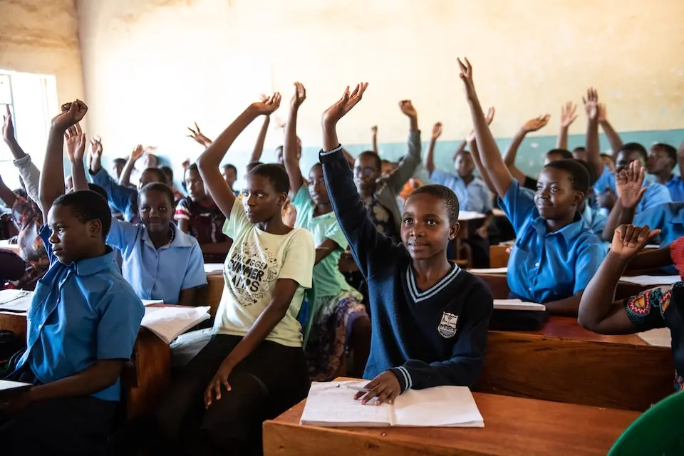 At a school in Malawi, students sit at desks delivered by the K.I.N.D. Fund.
