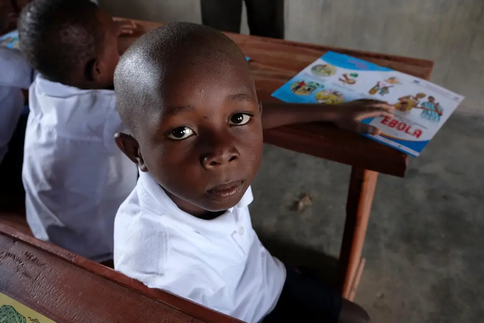A young boy in DR Congo learns about Ebola risks at school.