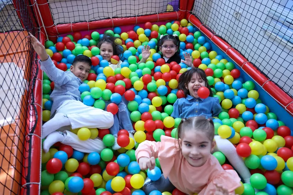 Children play in a ball pit as part of a psychosocial support session for kids in Türkiye.