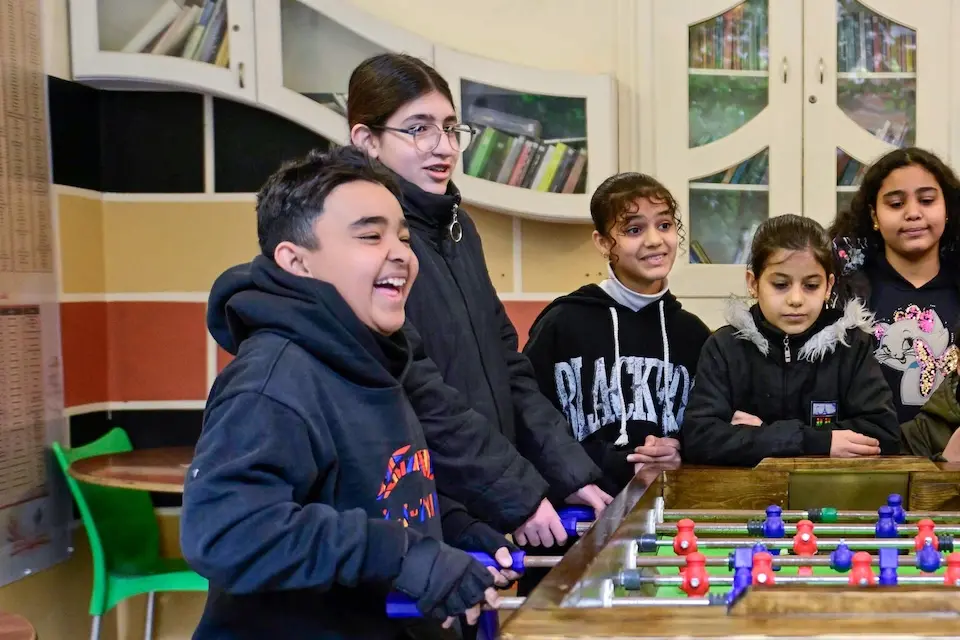 A group of adolescents in Syria play table football at a UNICEF-supported youth center.
