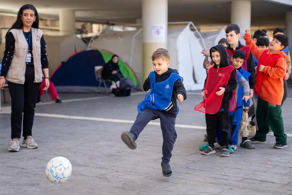 A child kicks a soccer ball outside Omar Faroukh school in Beirut, now a displacement shelter. 