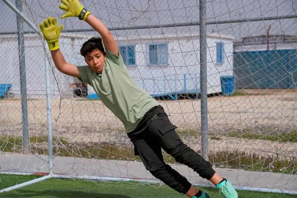 Mohammad, 13, plays goalie during a soccer game at Jordan’s Za’atari Camp, where UNICEF supports kids learning and personal growth