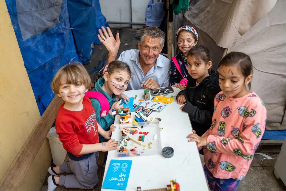 UNICEF spokesperson James Elder plays with children in a collective shelter in Beirut on April 24, 2026.