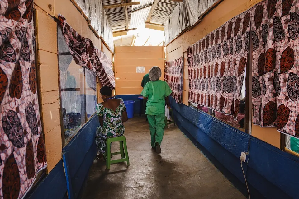 A health worker walks the hallway inside an Ebola treatment center.