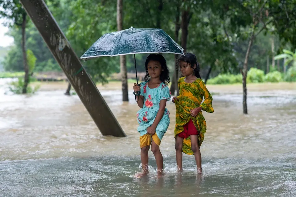 Girls stand in floodwaters in Feni, Bangladesh. 