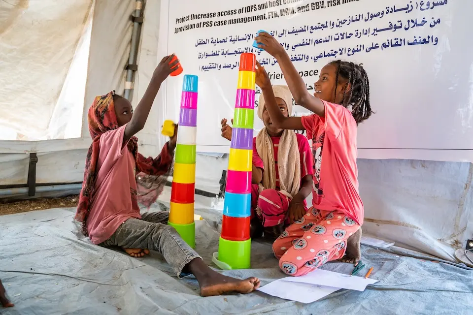 At Shagarab refugee camp in Kassala, Sudan, two girls play with stacking blocks.