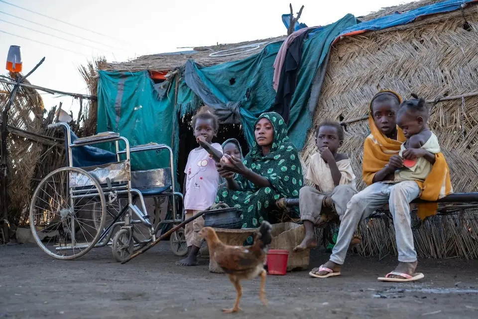 A mother and her children outside their home in rural Gedaref, Sudan.