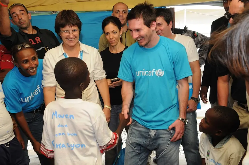 UNICEF Goodwill Ambassador Lionel Messi greets children at the UNICEF office in Port-au-Prince, Haiti in 2010.