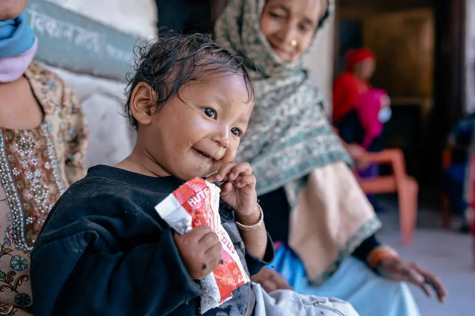 A malnourished toddler eats ready-to-use therapeutic food (RUTF) in Dolpa District, Nepal. 