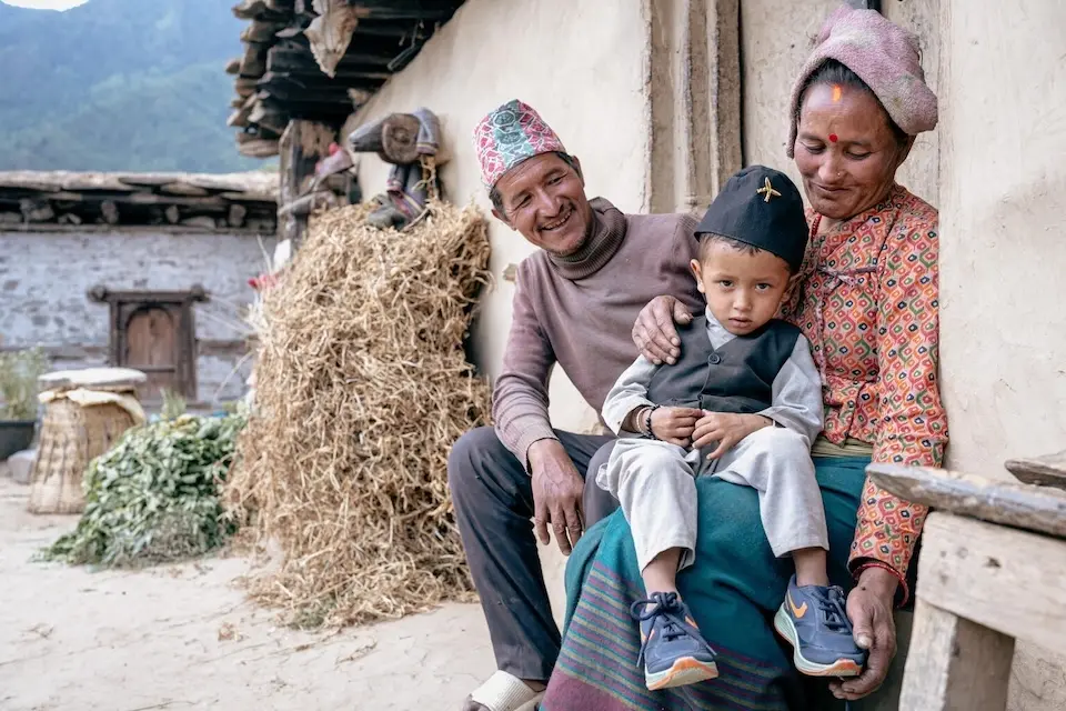 A 2-year-old with his parents outside their home in Juphal, Dolpa District, Nepal. 