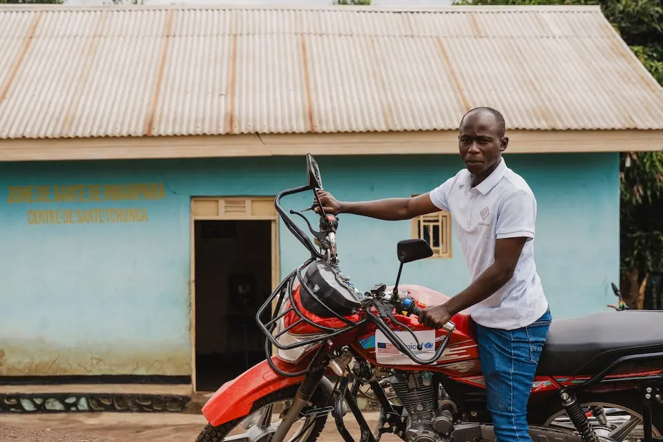 A health worker uses a motorcycle to access hard-to-reach places in DR Congo and facilitate Ebola response.