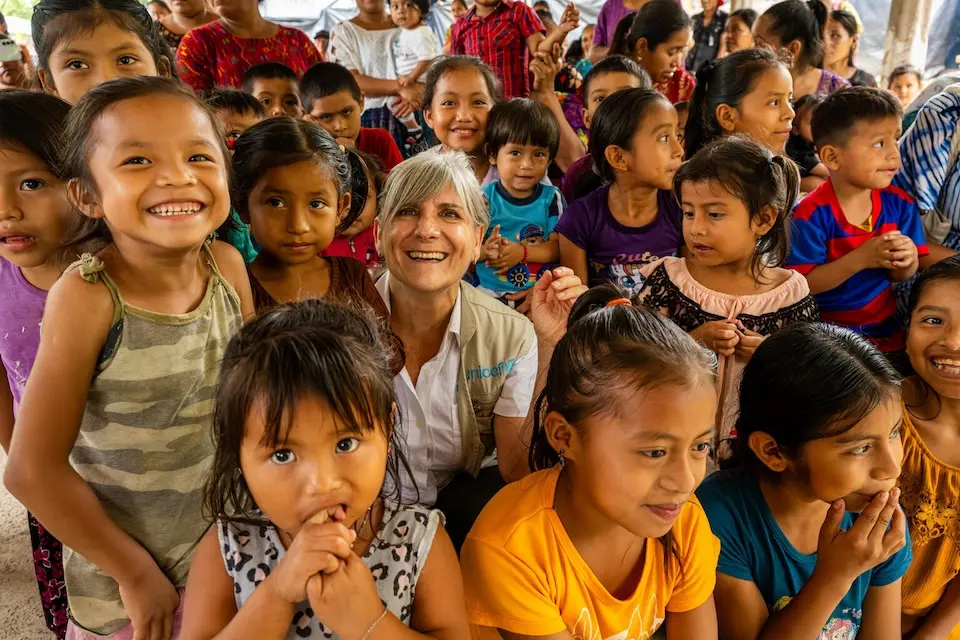Alejandra Trossero, Guatemala UNICEF Representative, smiles with children in the Cacao village to learn about improving health and nutrition practices. 