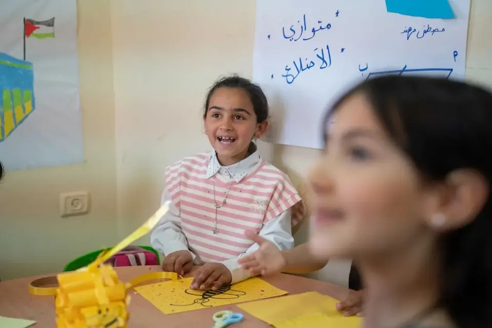 Malak, 8, laughs with her friends at a UNICEF-supported learning supportive space in her village in the West Bank.