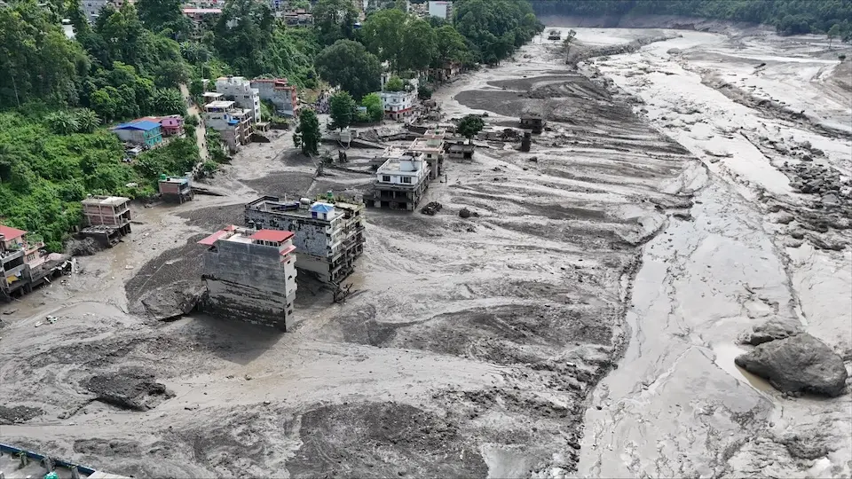 Views of settlements in Rasuwa District in central-northern Nepal covered in mud following the devastating flash floods that swept through the area on Aug. 26, 2026.