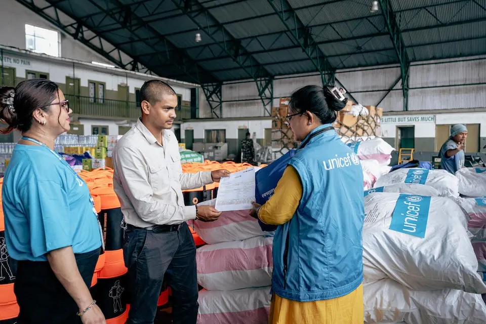 UNICEF staff load emergency supplies for delivery to flood-affected areas in Nepal on Aug. 27, 2026.
