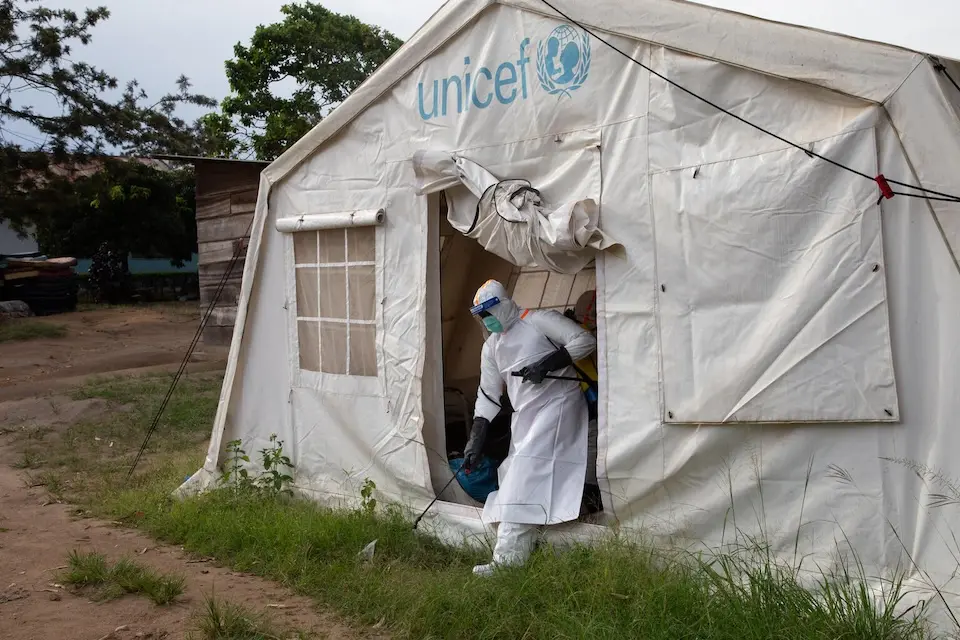 A medical team disinfects a tent  outside a hospital in Ituri Province, Democratic Republic of the Congo, in June. © UNICEF / UNI1001002 / John James