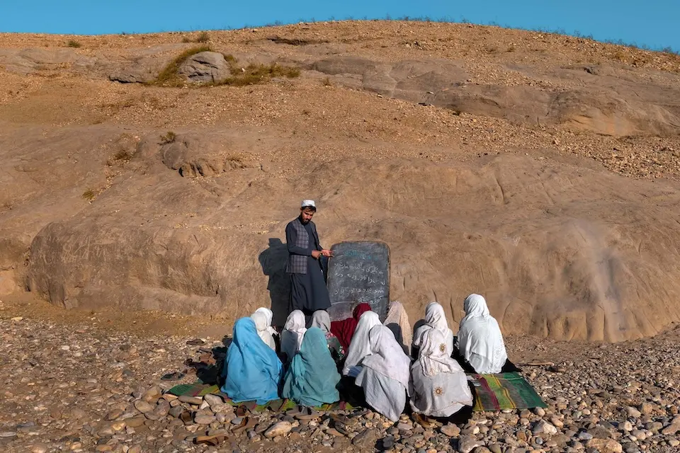 Girls attend an informal outdoor lesson in a remote area of Afghanistan .