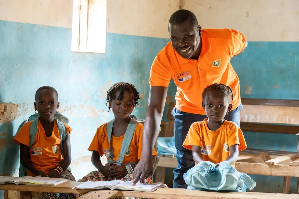 Yao Yao, a volunteer teacher, with his students in the remote village of Benjaminkro, south-western Côte d’Ivoire. 
