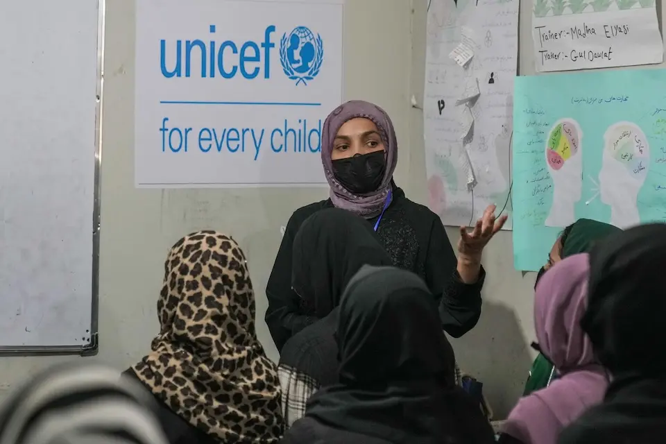 A girl in Afghanistan stands in front of her peers during a training program implemented with support from UNICEF