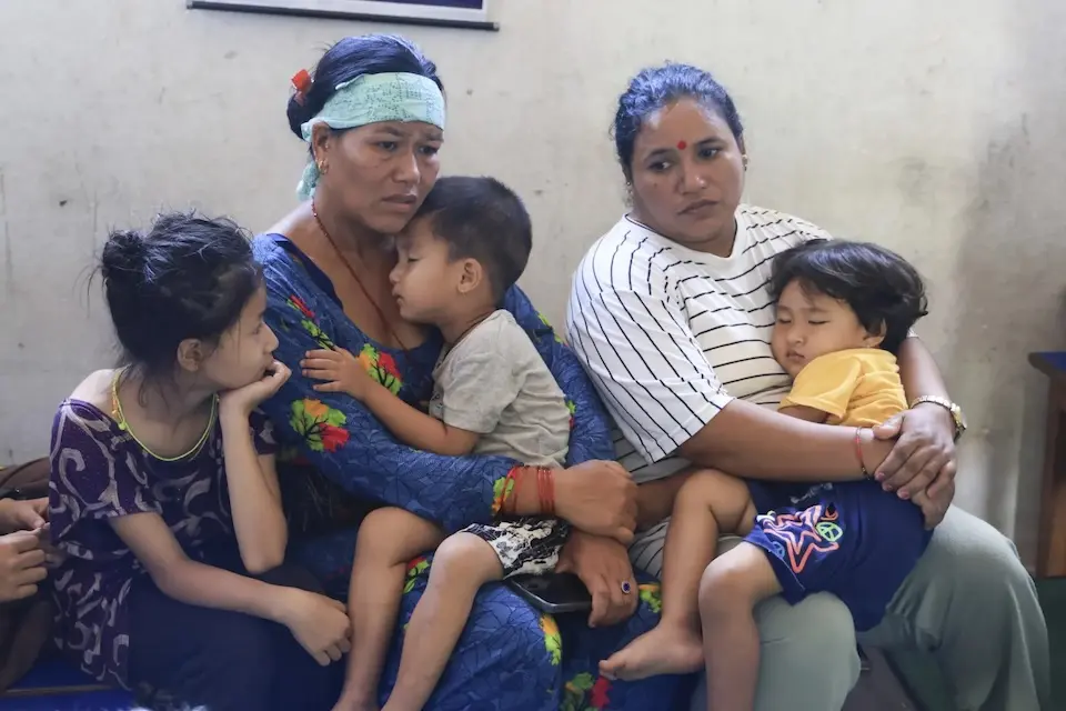 Mothers and children shelter in a school classroom after a massive flood destroyed their village in Nepal. 