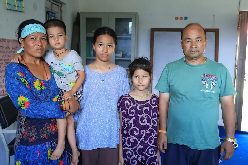 A family whose home was swept away by flooding in Nepal on Aug. 26, 2026.