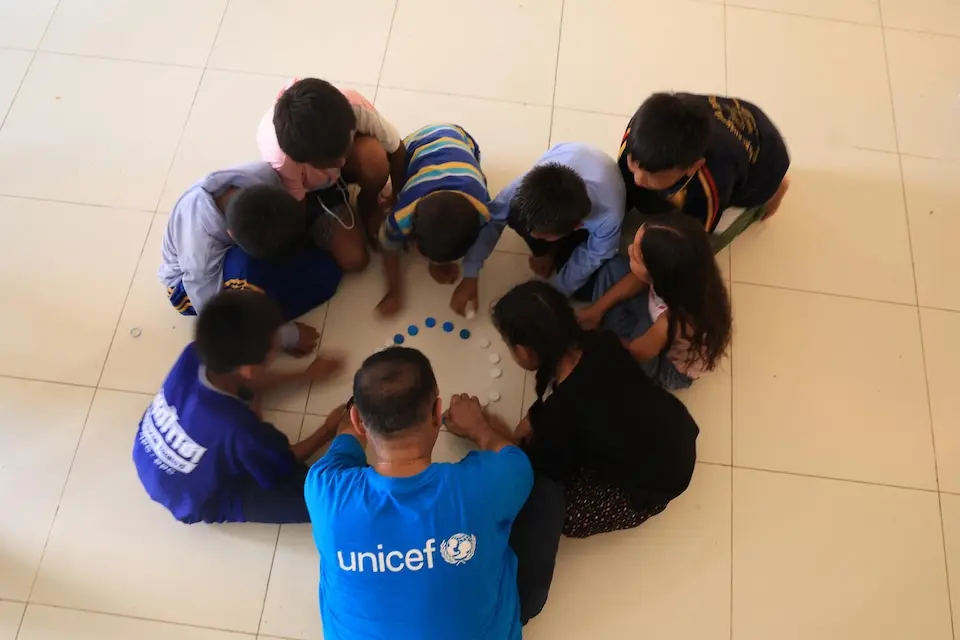Children take part in a group activity during a UNICEF-supported mental health and psychosocial support session in Nepal's Nuwakot district after massive flooding in August 2026.