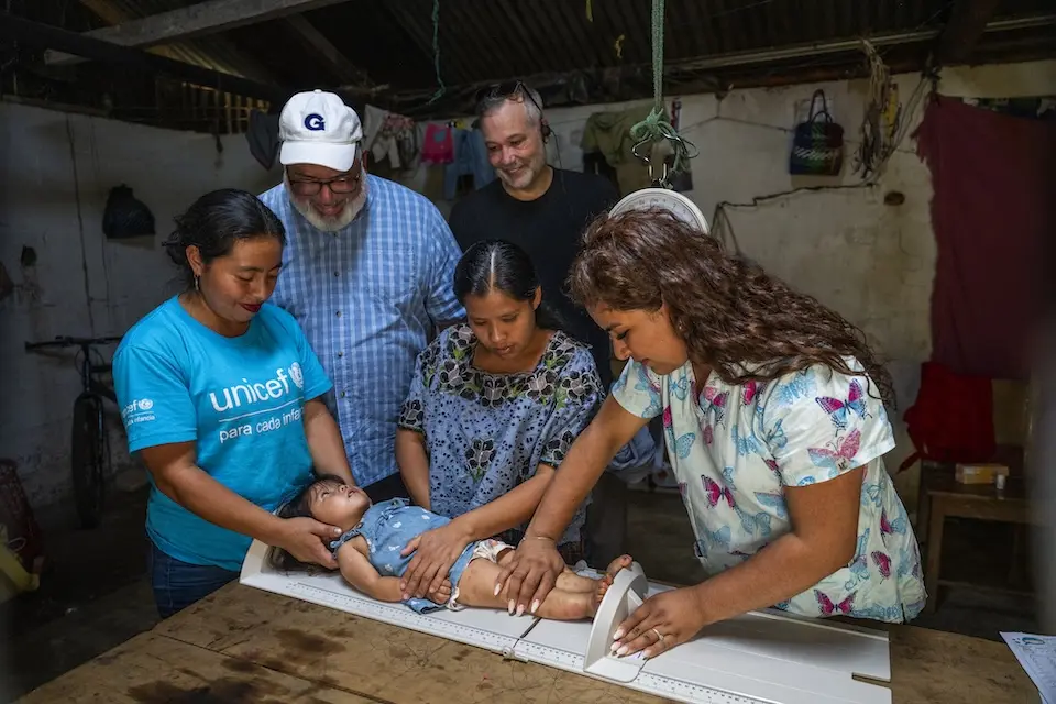 A young child is measured as part of a UNICEF-supported health screening in Guatemala.