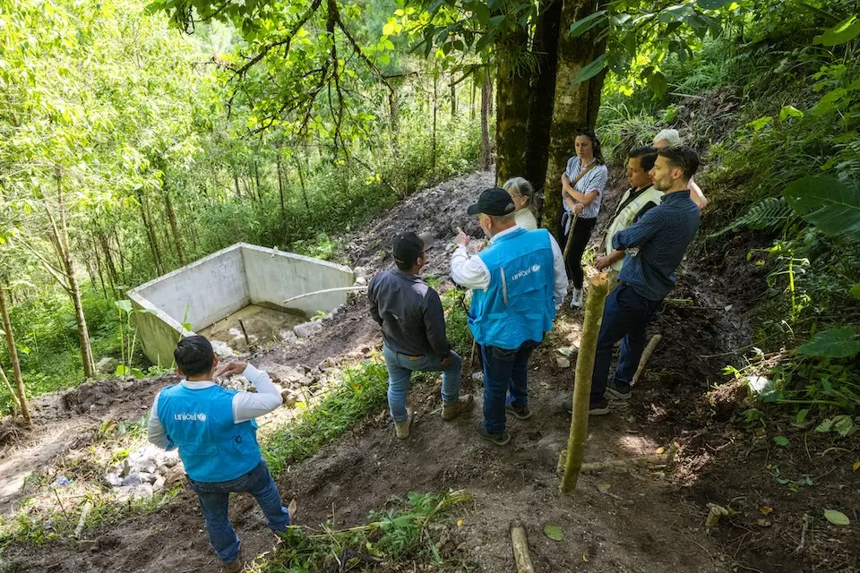 UNICEF staff and visitors view WASH facilities in San Cristobal Verapaz during a program visit to Guatemala. 
