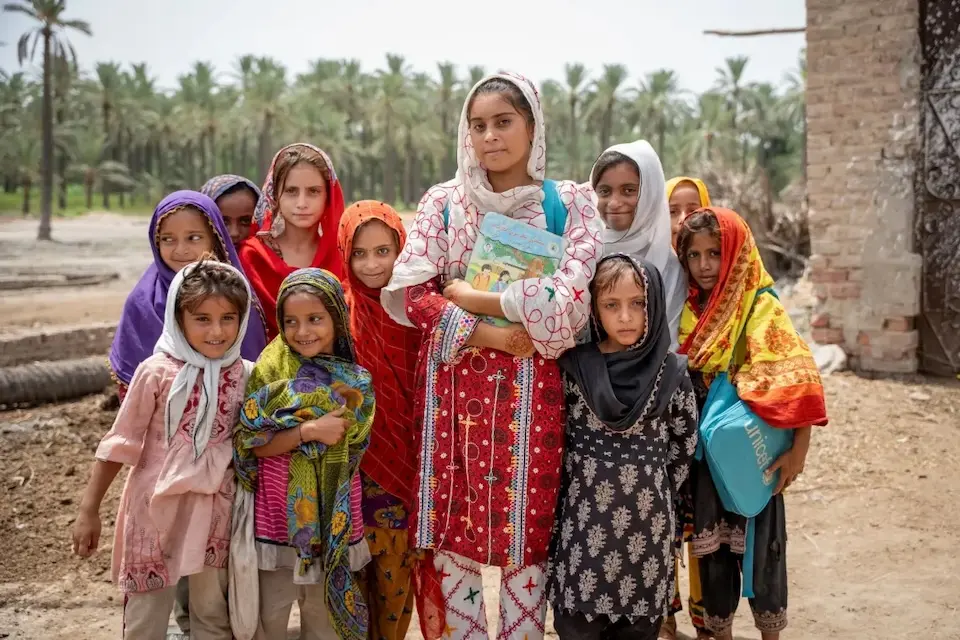 Sadia, a teacher in Pakistan, surrounded by students.
