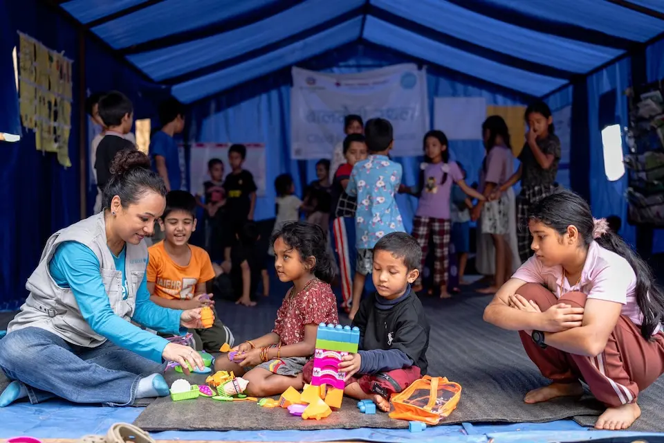 Children draw and play inside a UNICEF-supported child-friendly space in Bagmati Province on Sept. 11, 2026 after devastating floods swept through Nepal.
