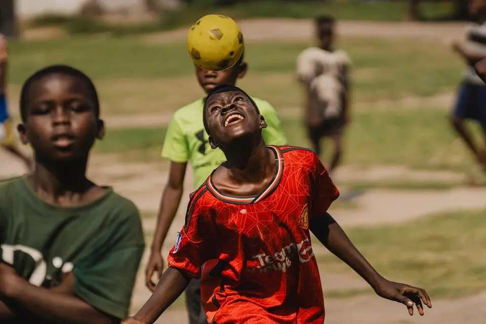 Students play football in the courtyard of Kasenyi Primary School in Irumu Territory, Ituri Province, Democratic Republic of the Congo.
