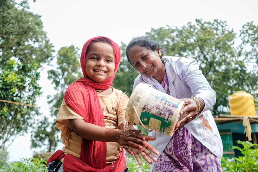 Four-year-old Mishti shows her sparkling clean hands in India.