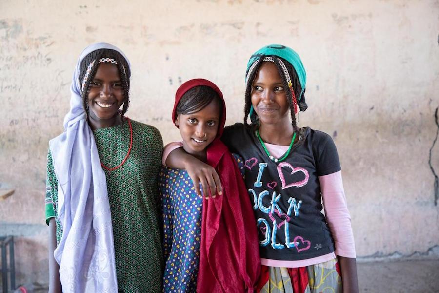 Displaced by conflict in northern Ethiopia, 11-year-old Asya, center, and her family fled to Chifra in Afar region.