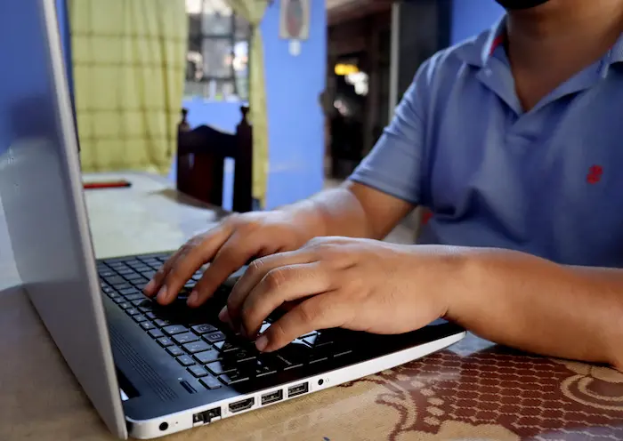 In Peru, teacher Carlos Espinoza types lesson plans. 