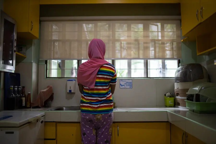 Person Washing Hands in Sink