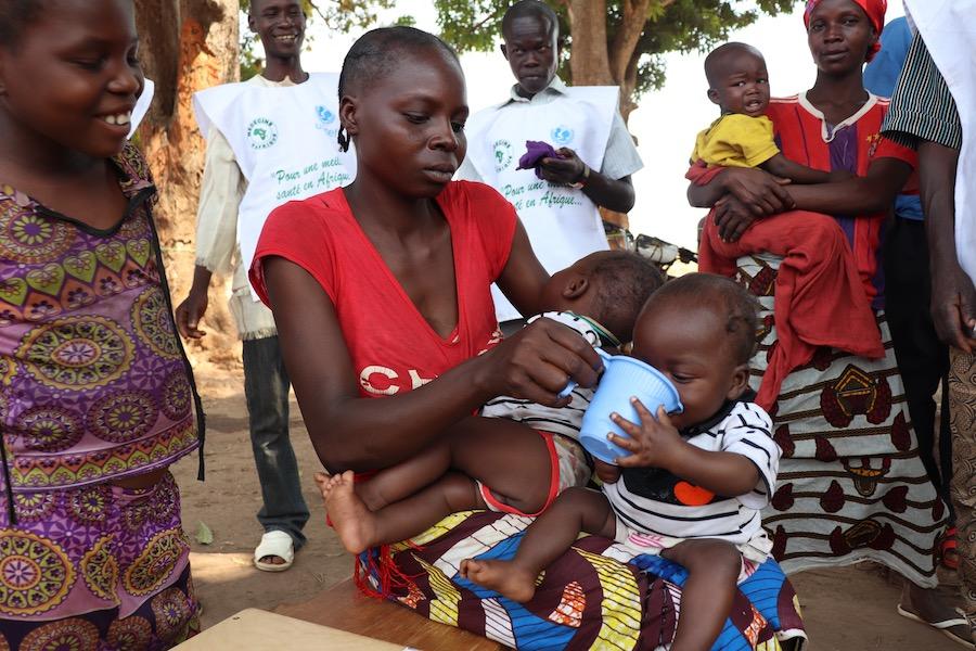 A mother feeds her malnourished babies at a UNICEF nutirition screening in the Central African Republic. 