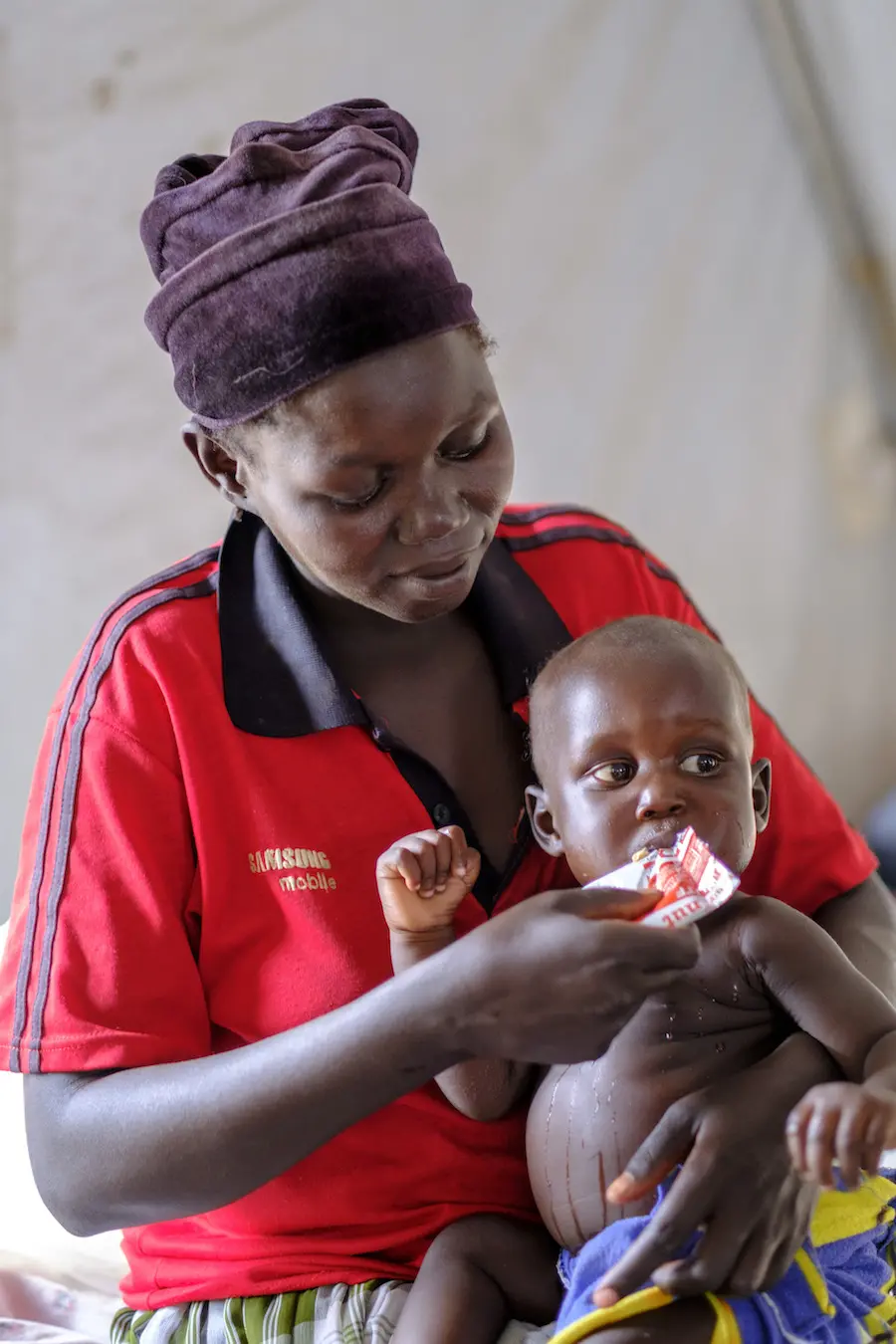 A recently arrived refugee from South Sudan feeds her baby in Bidi Bidi Refugee Settlement in Yumbe district, Uganda. A recently arrived refugee from South Sudan feeds her baby in Bidi Bidi Refugee Settlement in Yumbe district, Uganda.