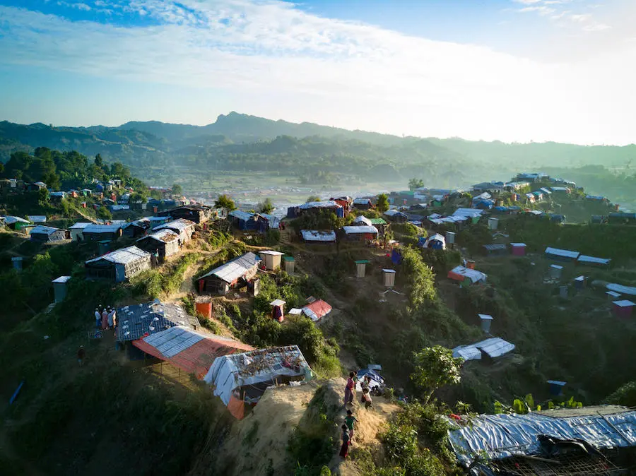 Rohingya refugee children stand atop a narrow path hugging a steep slope at the Unchiprang spontaneous site, Cox's Bazar District, Bangladesh, January 2018. Rohingya refugee children stand atop a narrow path hugging a steep slope at the Unchiprang spontaneous site, Cox's Bazar District, Bangladesh, January 2018.