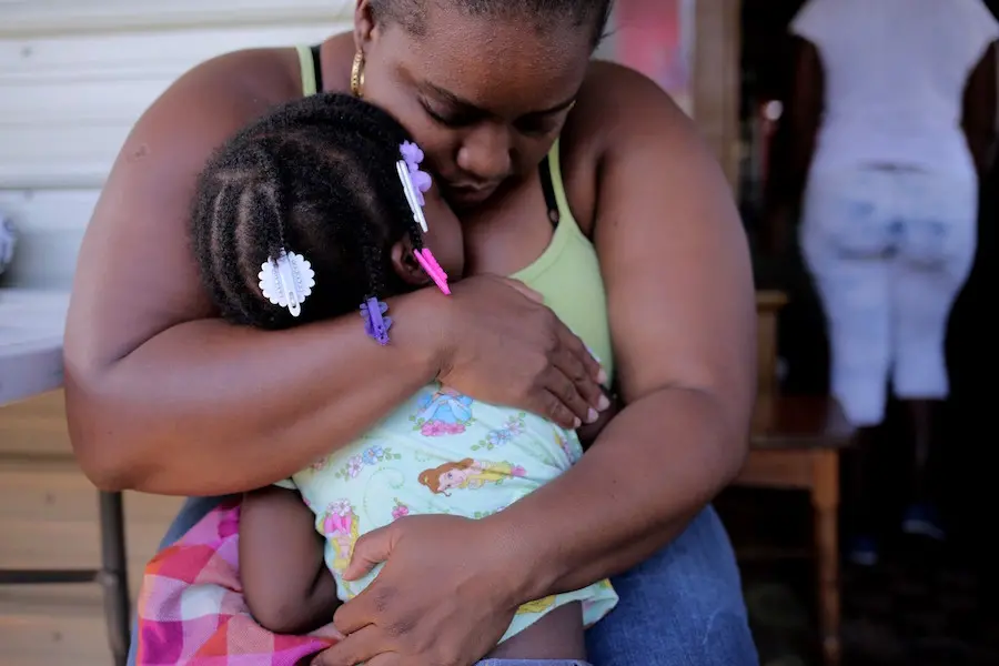 Person hugging child