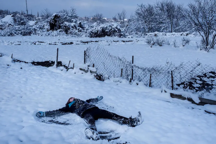 Anya, 13, plays in the yard in the town of Avdiivka, Donetsk Oblast, Ukraine in November 2017. Anya and her family moved into a relative's house after theirs was destroyed twice by shelling. Anya, 13, plays in the yard in the town of Avdiivka, Donetsk Oblast, Ukraine in November 2017. Anya and her family moved into a relative's house after theirs was destroyed twice by shelling.