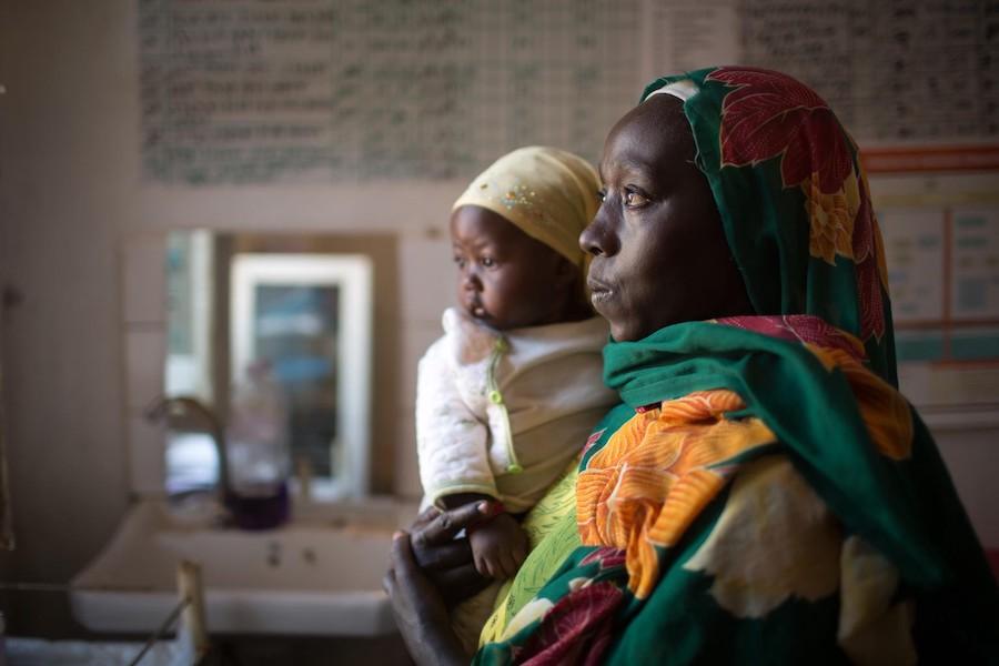 Hawa Mustafa holds her 6-month-old daughter, Muna Ibrahim, at the UNICEF-supported Homosha health center in Ethiopia's remote Benishangul-Gumuz region. 