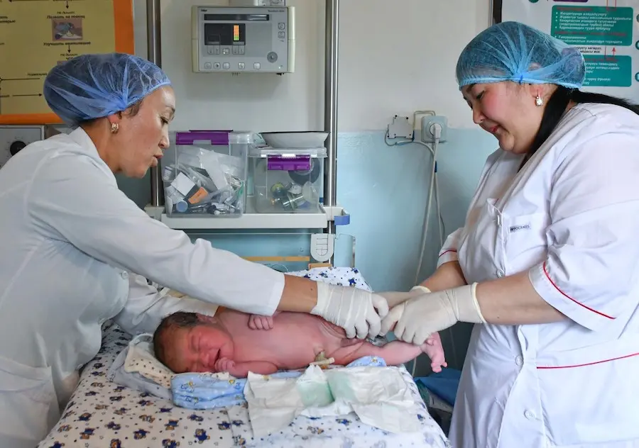 In Kyrgyzstan, Dr. Baktygul Pakirova and midwife Zhypar Sattarova perform the first check on a healthy newborn. In Kyrgyzstan, Dr. Baktygul Pakirova and midwife Zhypar Sattarova perform the first check on a healthy newborn.